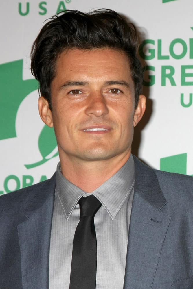 Orlando Bloom sported a messy pompadour hairstyle with his dapper gray suit at the Global Green Hosts Book Lauch of "ARCTICA: The Vanishing North" at the Four Seasons Hotel Los Angeles on October 29, 2015.