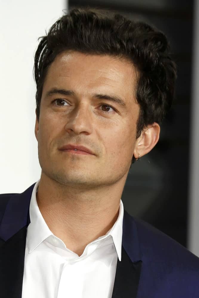 Orlando Bloom looked positively dreamy in his navy blue suit and messy pompadour hairstyle at the Vanity Fair Oscar Party on February 22, 2015 in Beverly Hills, CA.