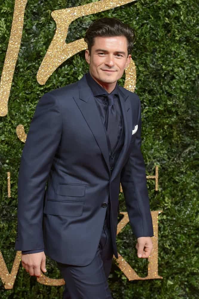 Orlando Bloom's handsome bone structure is on full display with his brushed-up undercut hairstyle with a slight pompadour look at the 2015 British Fashion Awards at the Coliseum Theatre in London.