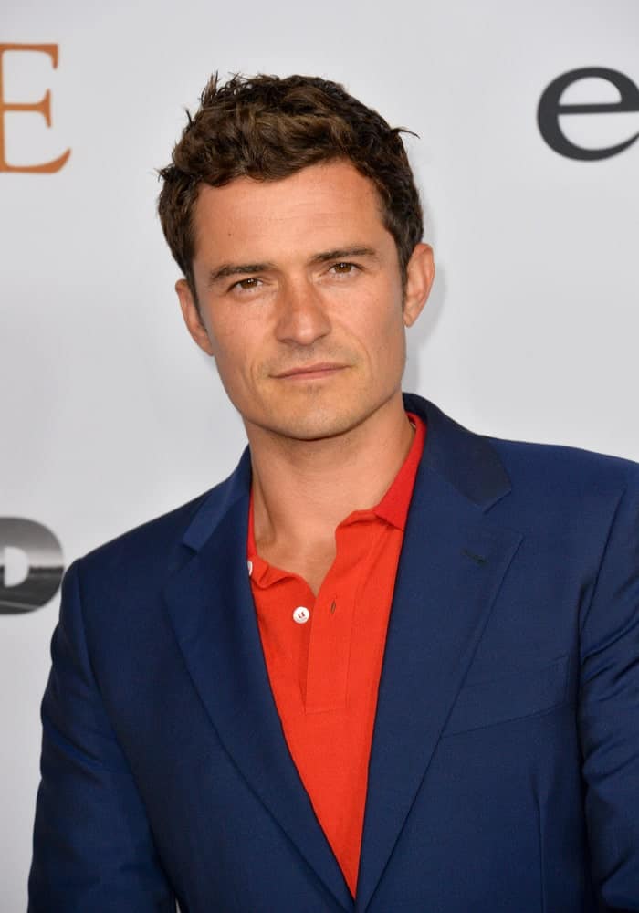 On April 12, 2017, actor Orlando Bloom attended the premiere of "The Promise" at the TCL Chinese Theatre in Hollywood. He wore a smart casual outfit to go with his spiked short curly hair.