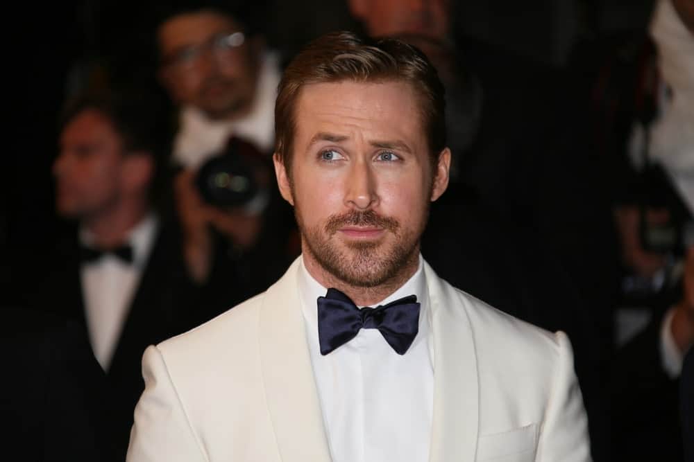 Ryan Gosling's vintage white suit and bow tie worked great with his trimmed beard and slick pompadour hairstyle at the 'The Nice Guys' premiere at the Palais des Festivals on May 15, 2016 in Cannes, France.