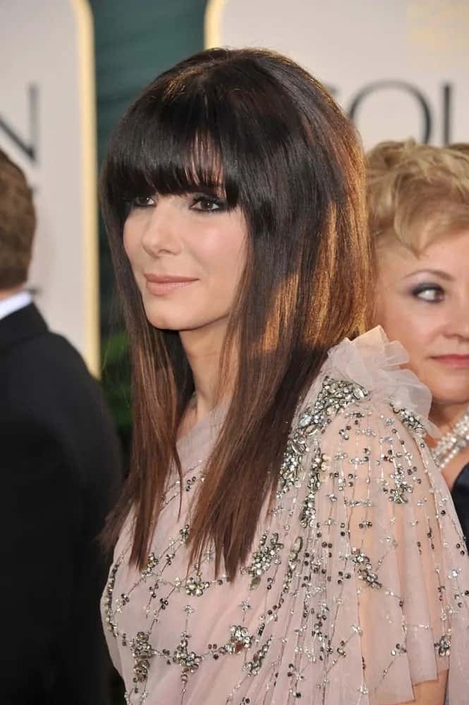 Sandra Bullock was at the 68th Annual Golden Globe Awards back on January 16, 2011. She wore a lovely sheer dress with her straight and layered hair complemented by blunt bangs.
