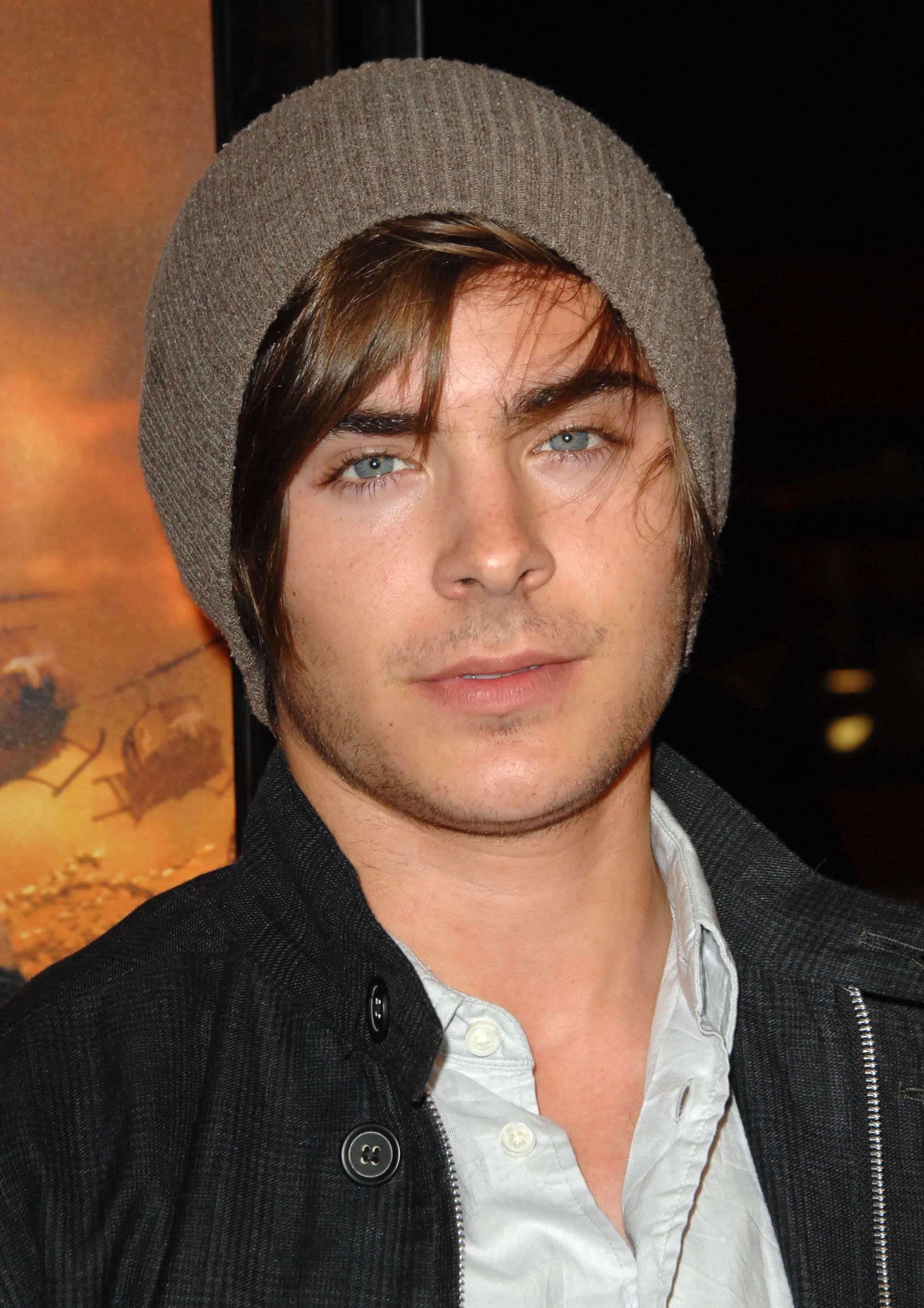 Zac Efron with a stylish outfit and a beanie bonnet covering his side-swept hairstyle. The photo was taken on March 2, 2009 at the Grauman's Chinese Theatre in Los Angeles, California.