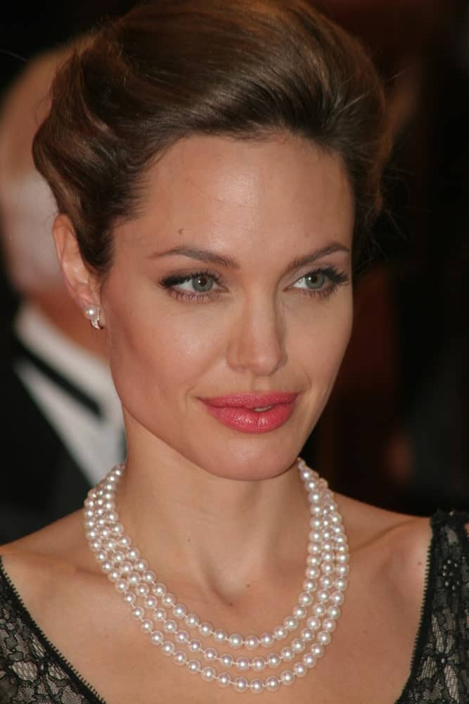 Angelina Jolie attended the premiere of ‘The Assassination of Jesse James by the coward Robert Ford’ at the 64th Venice Film Festival on September 2, 2007, in Venice. She wore a lovely black dress with her pearl necklace and tousled upstyle hair.