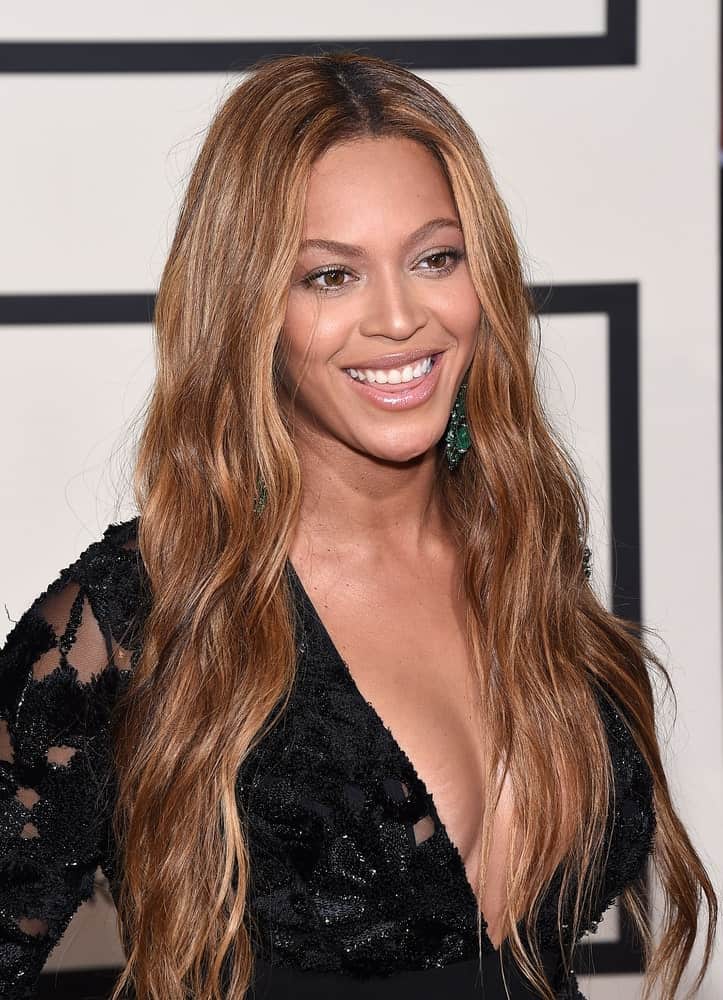 Beyonce Knowles arrived for the Grammy Awards 2015 on February 8, 2015, in Los Angeles, CA sporting a long wavy brown hairstyle that she paired with a black lace gown.