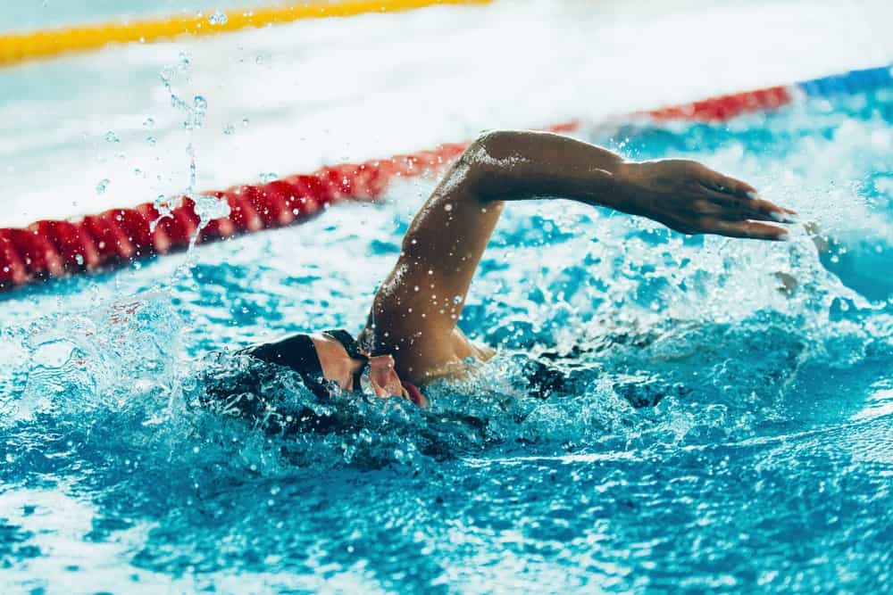 An athlete swimming toward the finish line.