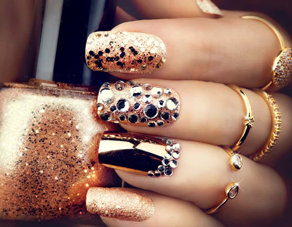 Gold bejeweled nail polish art.