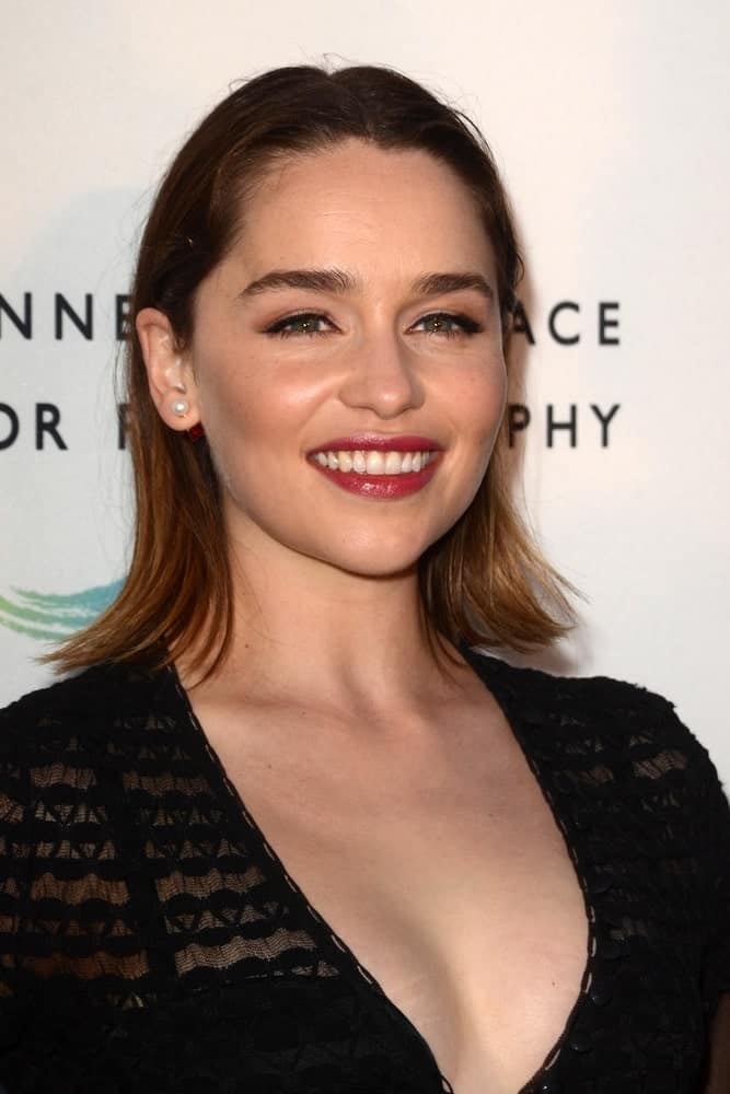 Emilia Clarke in her medium straight hair at the Annenberg Space for Photography 2016. She is looking really classy and sophisticated in her black see-thru dress and straight bob cut hair.