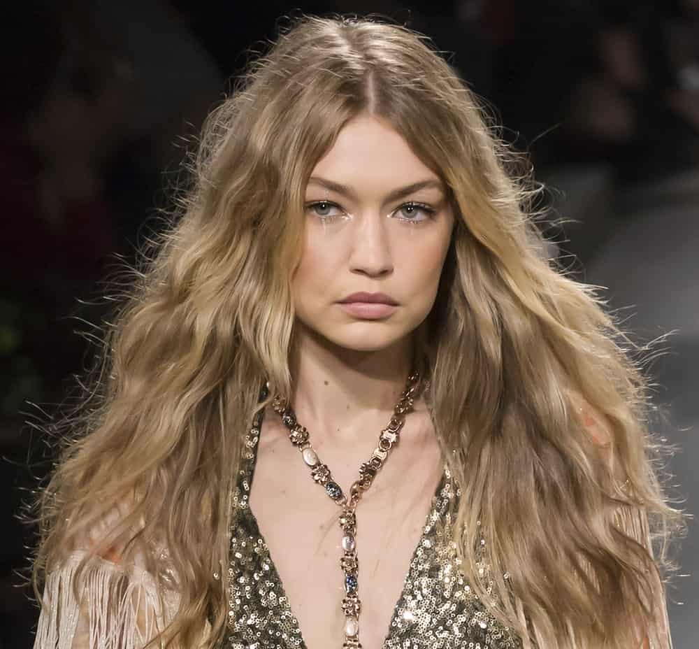 On September 11, 2017, Gigi Hadid walked the runway at the Anna Sui Spring Summer 2018 fashion show during New York Fashion Week. She was dressed in a sequined piece and her hair was loose, tousled and wavy.