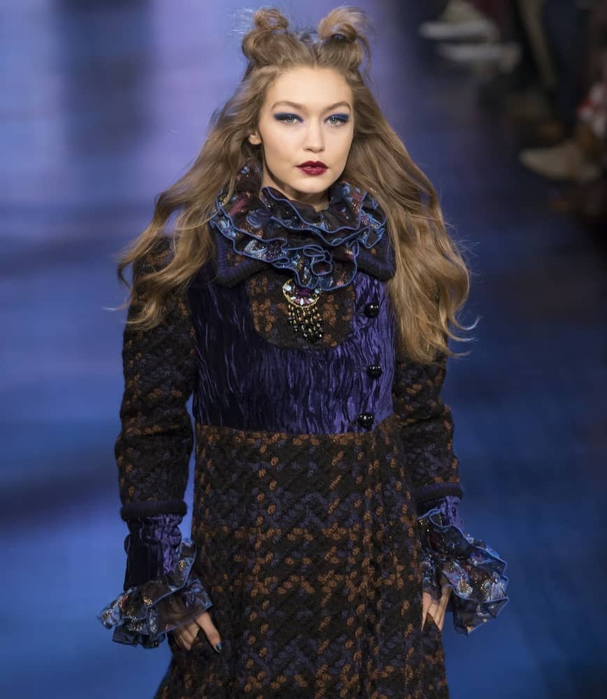 Gigi Hadid walked the runway at the Anna Sui Fall Winter 2017 fashion show during New York Fashion Week on February 15, 2017. She wore a detailed dress to go with her half-up hairstyle that has two small buns to imitate cat ears.