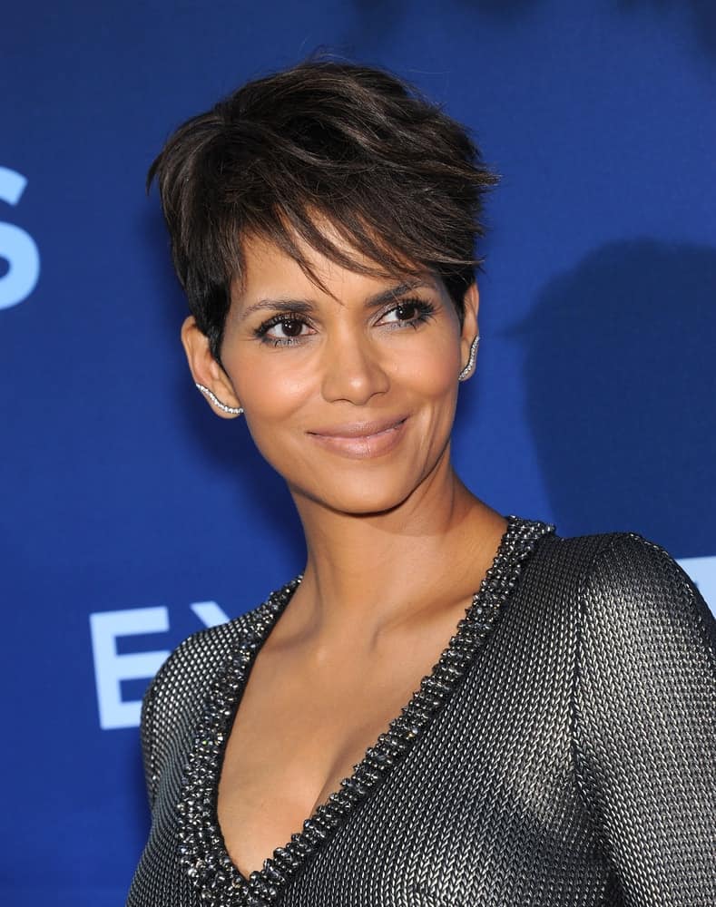 Halle Berry attended the ‘Extant’ Premiere Party on June 06, 2014, in Los Angeles, CA. She wore a stylish metallic gray dress that she paired with her raven pixie hairstyle with side-swept wispy bangs.