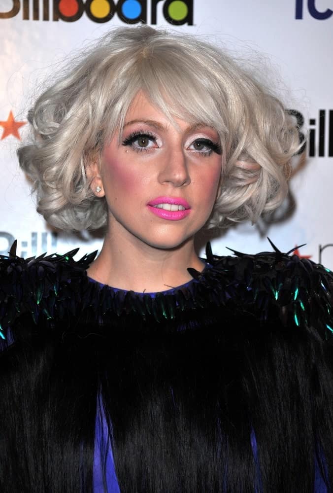 Lady Gaga was at the Billboard’s Women in Music Brunch held at The Pierre Hotel in New York on October 2, 2009. She caught the attention of everyone with her unique blue dress with black details and her hair was styled with short tousled white-blond curls.
