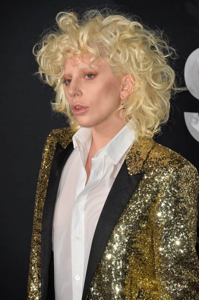 On February 10, 2016, singer Lady Gaga attended the Saint Laurent at the Palladium fashion show at the Hollywood Palladium. She was seen wearing a golden sequined jacket topped with a tousled curly hairstyle almost like an afro.