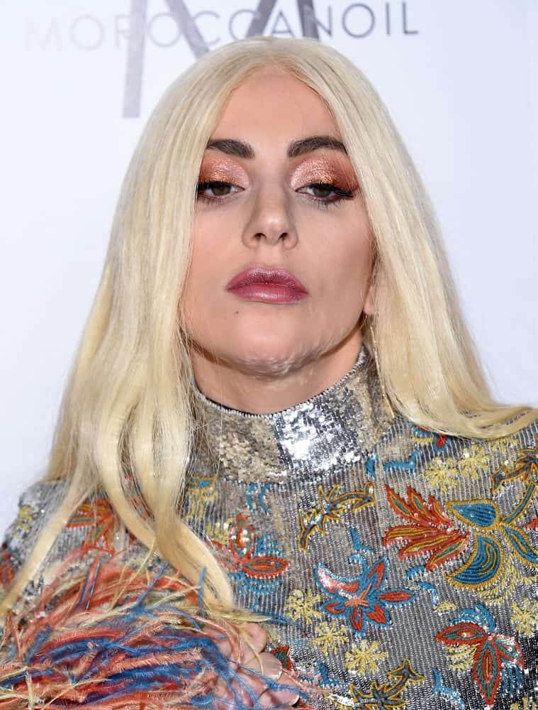 Lady Gaga wore a colorful bodysuit with floral details and silver sequins to go with her long, straight center-parted white-blond hair when she arrived at the 2nd Annual Fashion Los Angeles Awards on March 20, 2016, in Hollywood, CA.