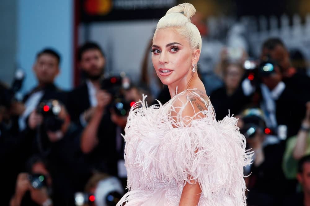 Lady Gaga wowed everyone with her absolutely stunning frilly white dress that went great with her white-blond hair that is styled up into a top knot at the premiere of her movie ‘A Star Is Born’ during the 75th Venice Film Festival on August 31, 2018, in Venice, Italy.