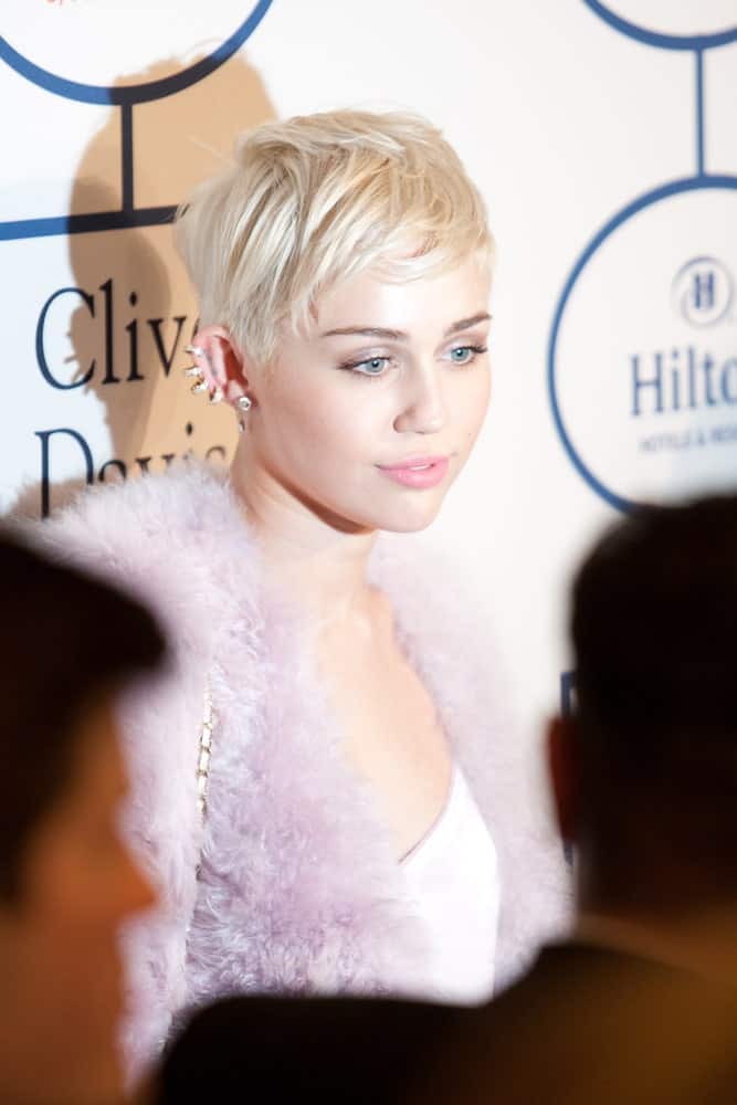 Miley Cyrus looked quite lovely with her short platinum blond hairstyle that is tousled to perfection to a lovely side-part look at the Clive Davis and The Recording Academy annual Pre-GRAMMY Gala on January 25th 2014 at the Beverly Hilton in Beverly Hills, California.