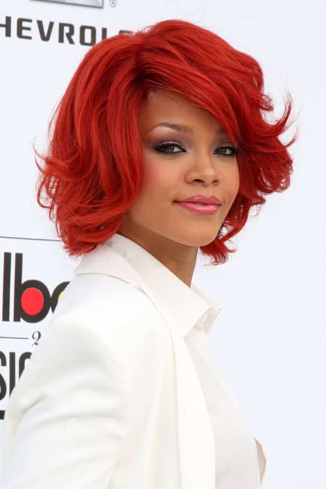 Rihanna was at the 2011 Billboard Music Awards at MGM Grand Garden Arena in Las Vegas, NV. She was lovely in her pure white outfit to contrast with her short tousled side-swept hairstyle that has a bright red tone.
