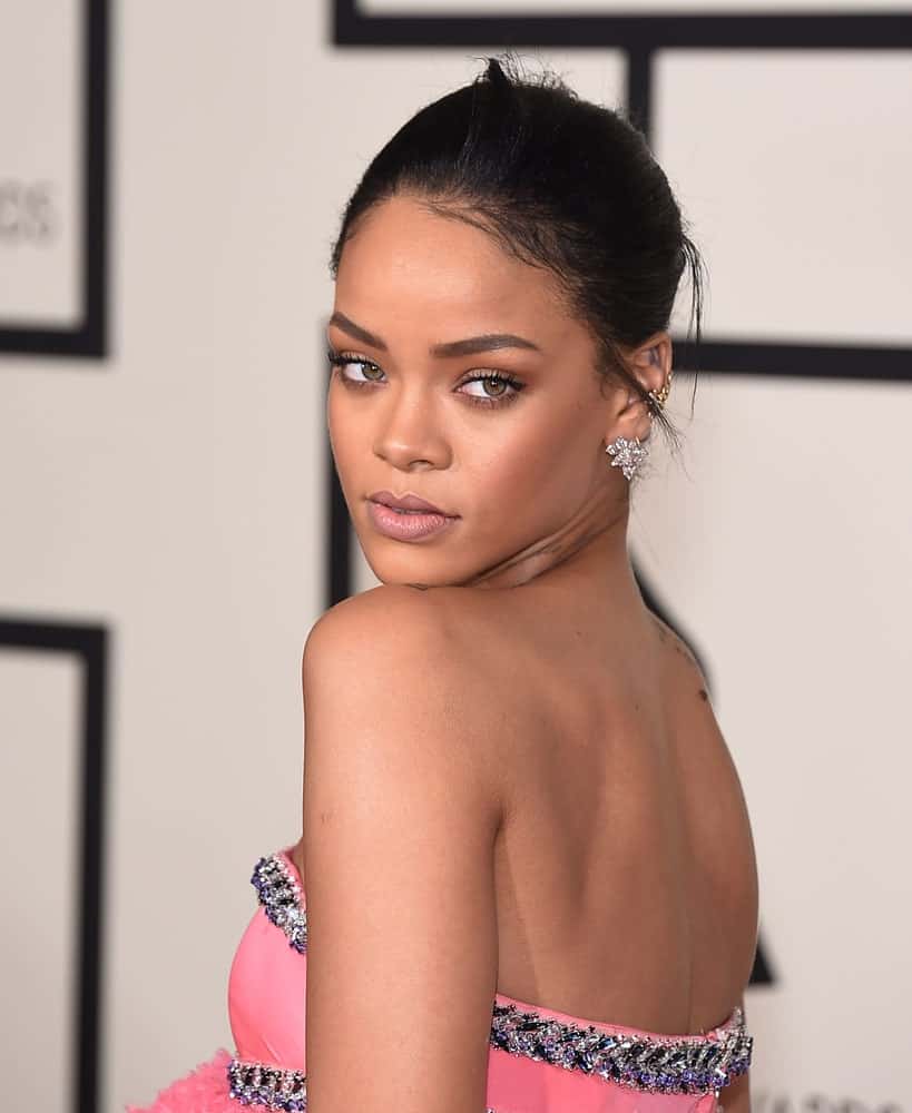 Rihanna attended the Grammy Awards 2015 on February 8, 2015, in Los Angeles, CA. She paired her charming pink strapless dress with a neat bun hairstyle with a few loose tendrils.