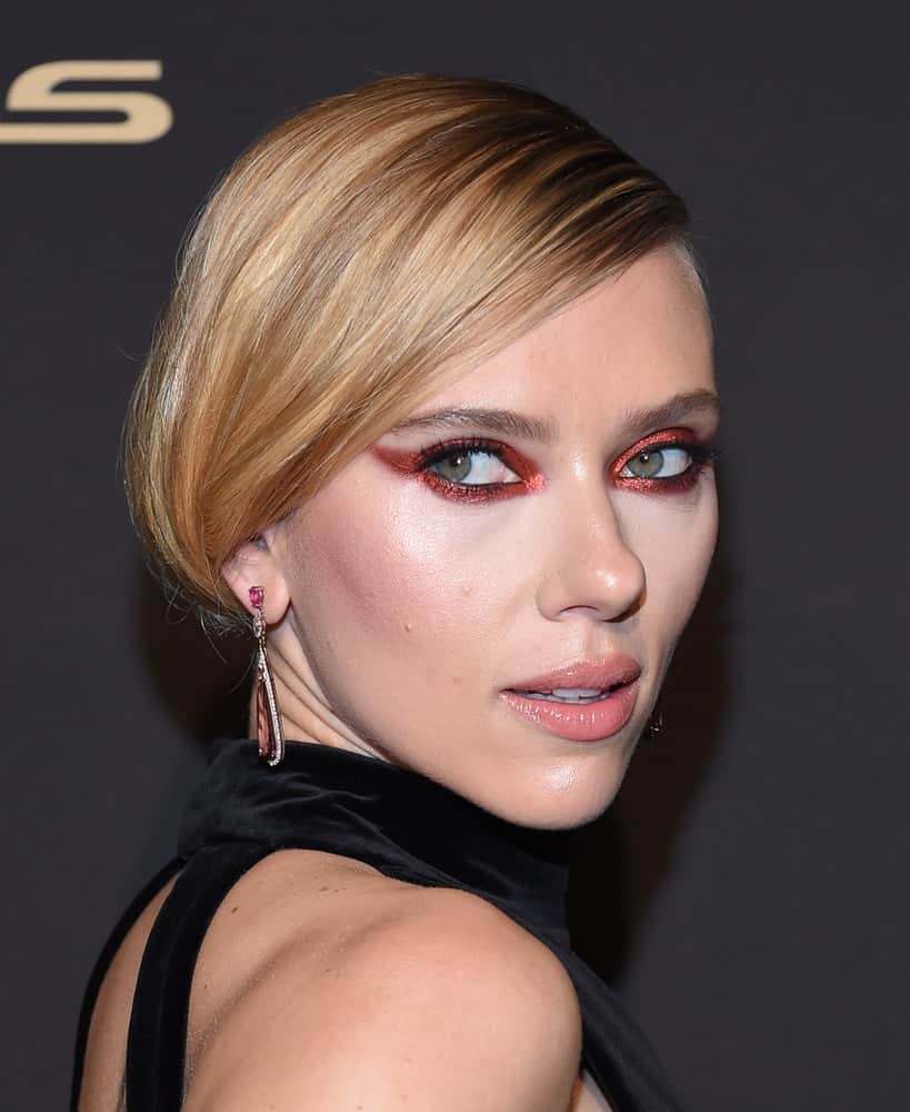 Scarlett Johansson attended the ELLE Women in Hollywood on October 14, 2019, in Westwood, CA. She stunned everyone with her black dress, smoky eyes and elegant low bun hairstyle with long side-swept bangs.