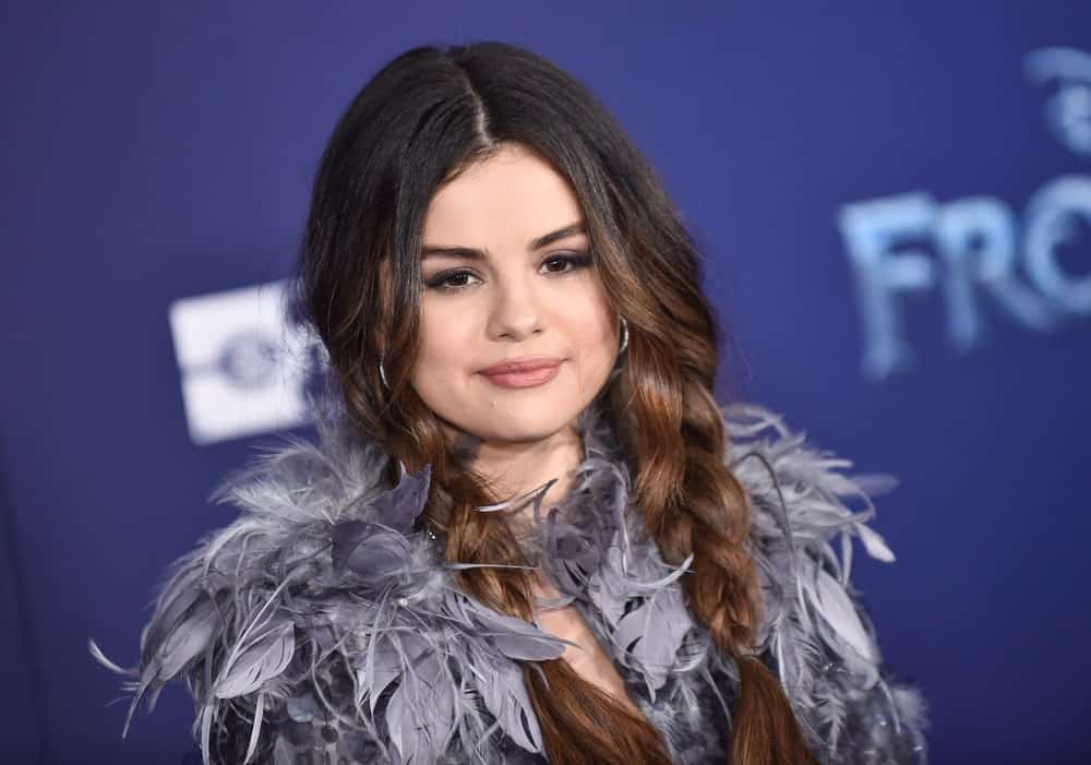Selena Gomez was at the ‘Frozen II’ Premiere on November 07, 2019, in Hollywood, CA. She came wearing a feathered gray outfit and paired it with a loose dual braided hairstyle that goes down on her shoulders.