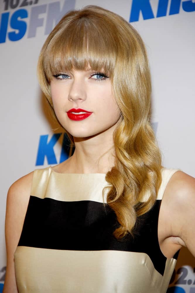 Taylor Swift gathered her blonde wavy hair on one side during the KIIS FM’s 2012 Jingle Ball held at the Nokia Theatre L.A. Live held on December 3rd.