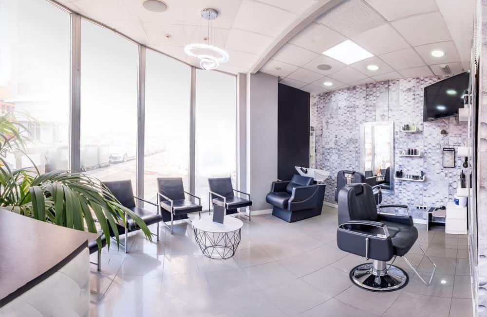 A bright and airy modern hair salon with rows of glass walls for a bright vibe.