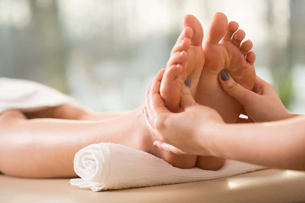 A woman having a reflexology foot massage.
