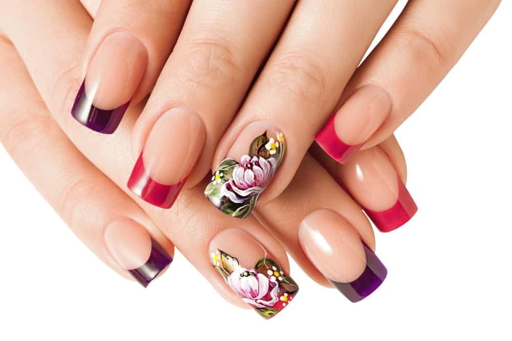 Close-up of a woman's hand with floral nail art manicure.