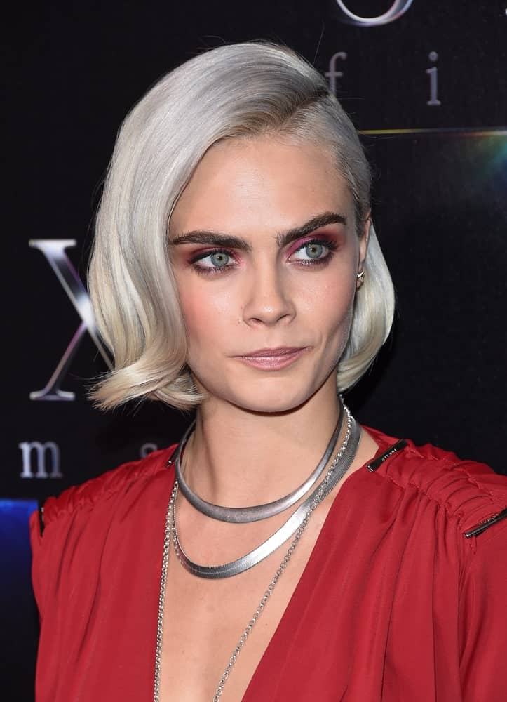 Cara Delevingne wore a charming red dress to match with her platinum blond chin-length hairstyle with a flippy finish and side-swept bangs at the CinemaCon 2017-STX Films "The State of the Industry: Past, Present and Future" Presentation on March 28, 2017, in Las Vegas, NV.