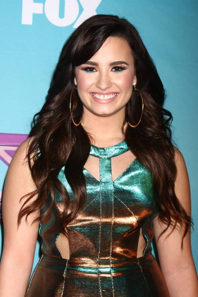 Demi Lovato was quite charming in her shiny dress and long wavy tousled dark hairstyle that has long side-swept bangs at the ‘X Factor’ Season Finale at CBS Television City on December 20, 2012, in Los Angeles, CA.
