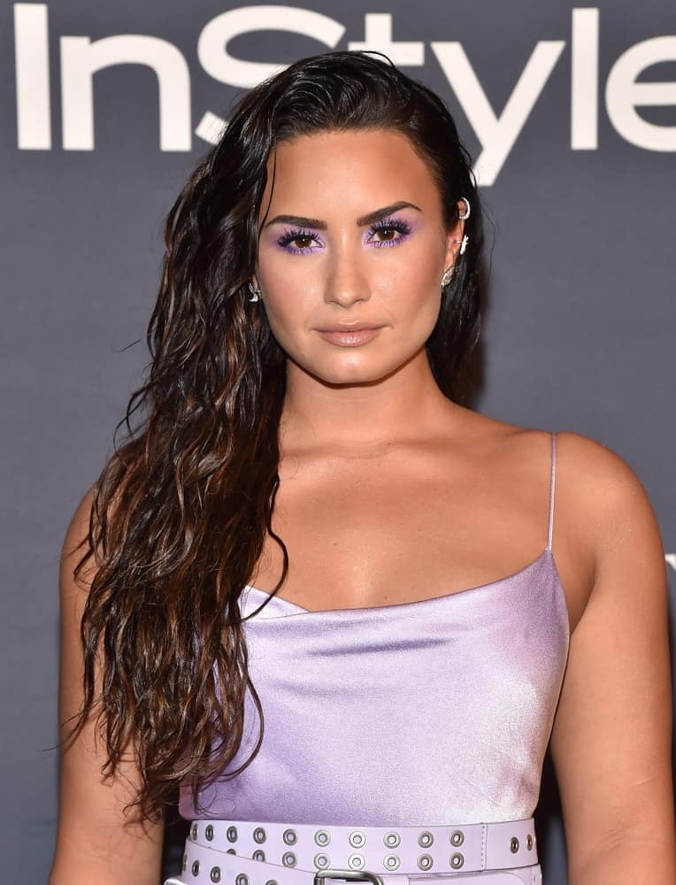 Demi Lovato paired her charming pearly dress with smokey eyes and a side-swept wavy hairstyle that has subtle highlights and a wet-look finish at the InStyle Awards on October 23, 2017, in Los Angeles, CA.
