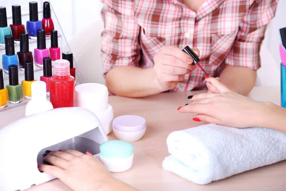 A woman having her nails done in a beauty salon.