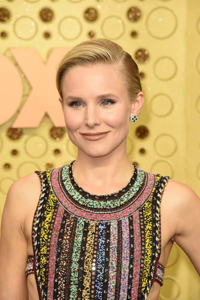 Kristen Bell in a colorful dress along with a side-swept updo as she attends the Primetime Emmy Awards at the Microsoft Theater on September 22, 2019.