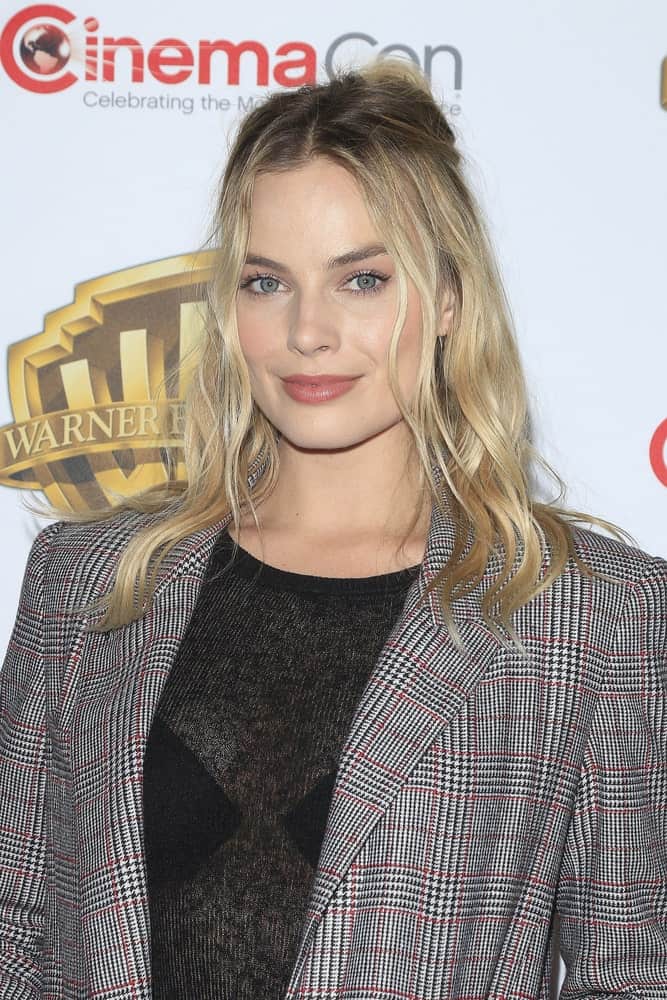 Margot Robbie attended the Warner Bros. Pictures Presentation during CinemaCon at Caesars Palace on April 12, 2016. She wore a gray check suit that complements her tousled half updo.