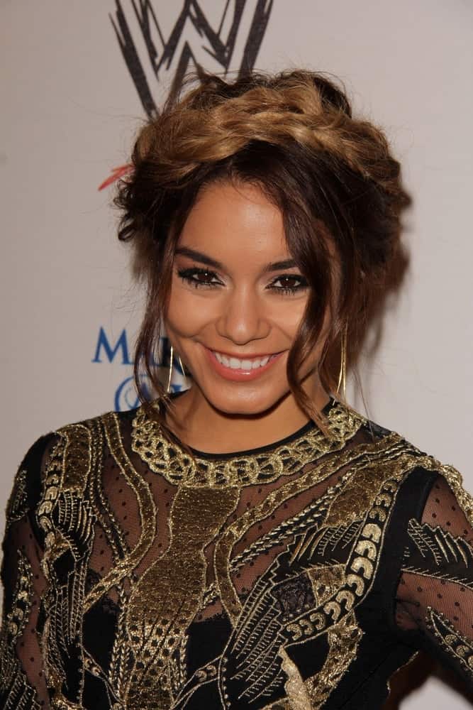 Vanessa Hudgens swept up her long highlighted hair with a messy upstyle incorporated with braids and loose tendrils at the Superstars for Hope honoring Make-A-Wish at the Beverly Hills Hotel on August 15, 2013, in Beverly Hills, CA.