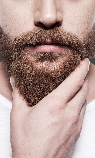 A man touching his beard.