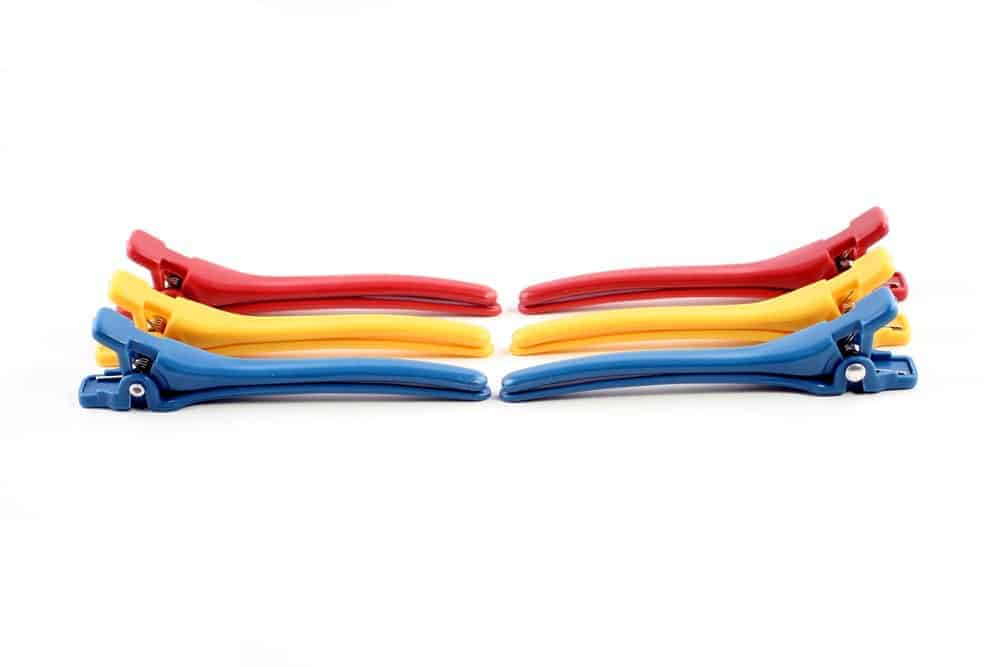 A pair each of red, yellow, and blue hinged barrettes.
