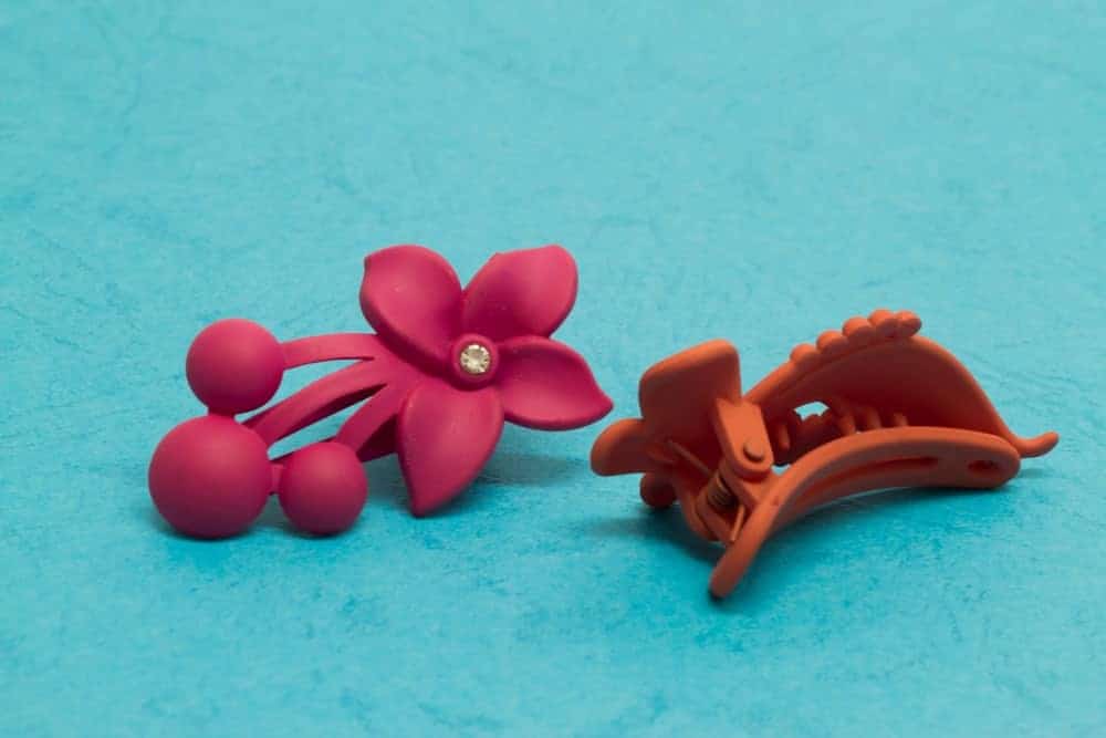 Mini-shaped hair clips on blue background.