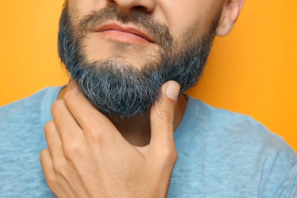 A close look at a man with a dyed beard.