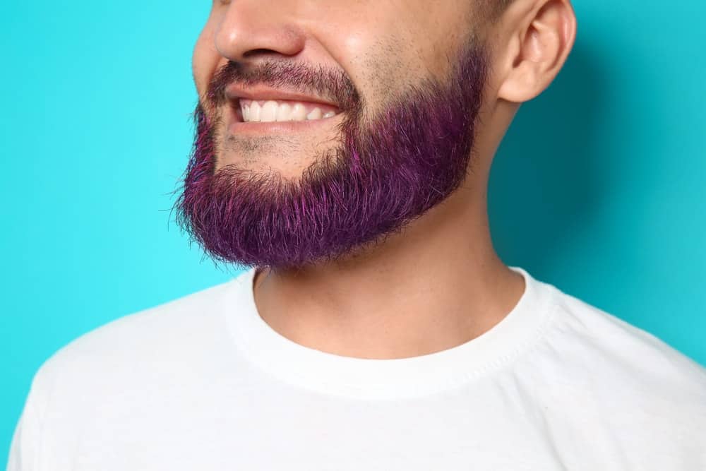 A man with purple-dyed beard.