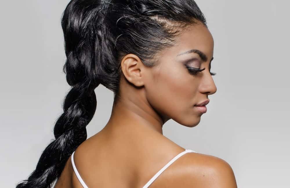 A woman with a single braid ponytail.