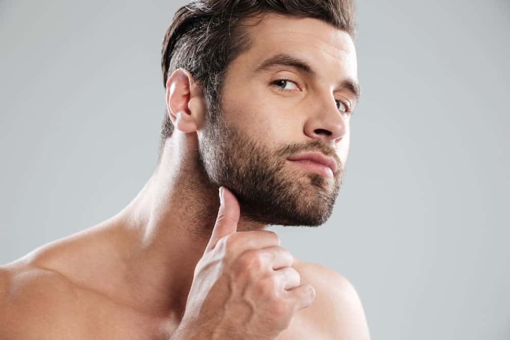 Man examining his beard.