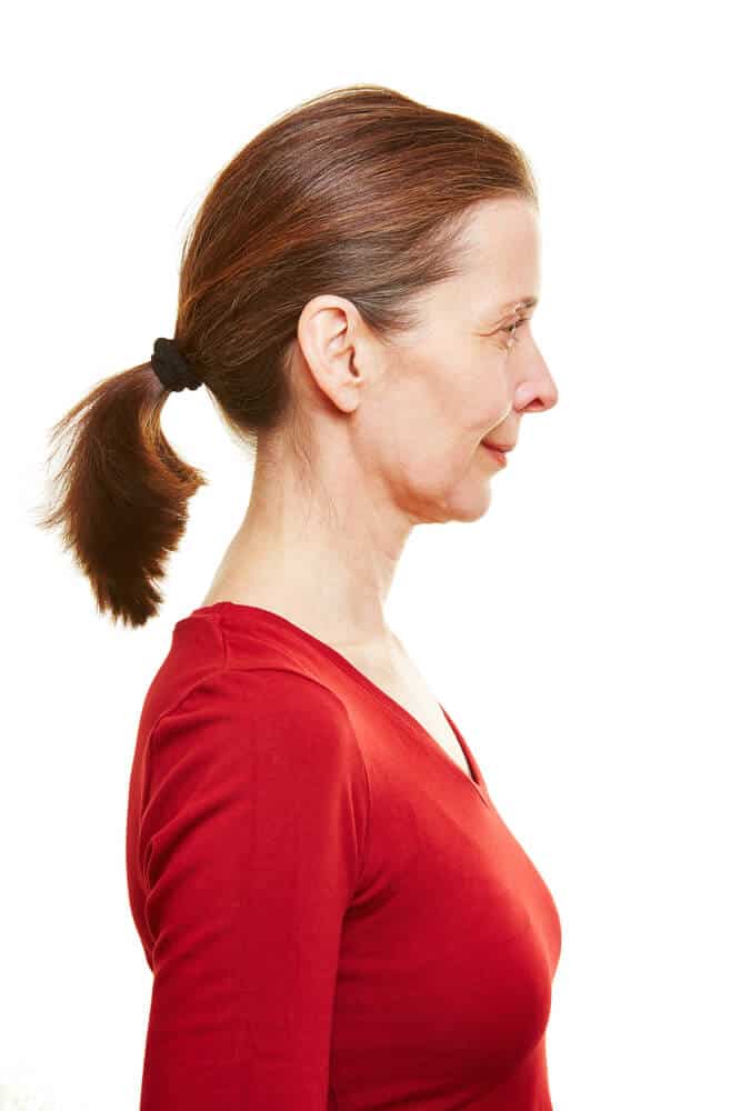 Side profile of an old woman with a ponytail.