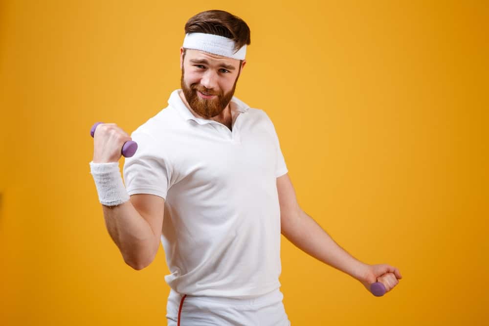 A man wearing a white headband while exercising.