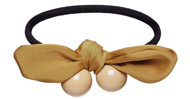 A close look at a ponytail barrette with a bow.