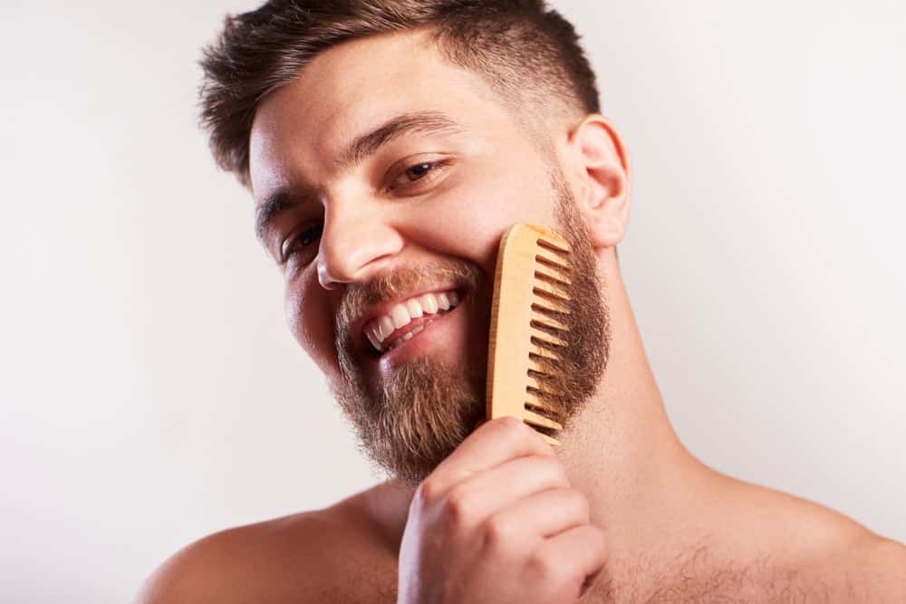 A man combing his beard.