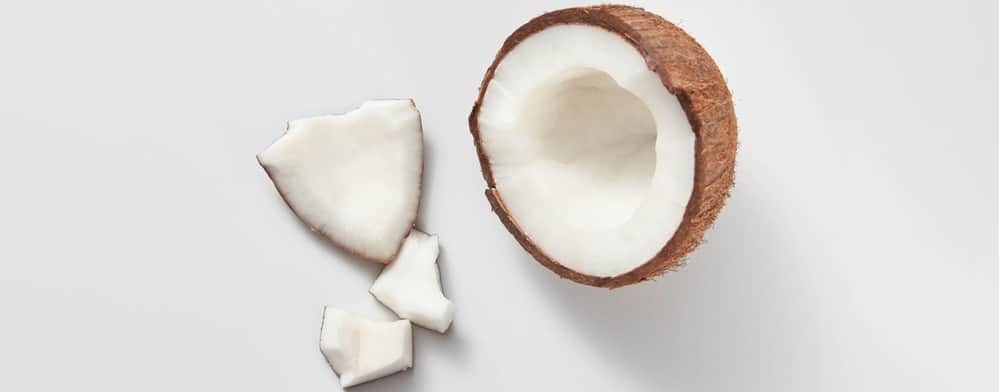 A fresh coconut on a white surface.