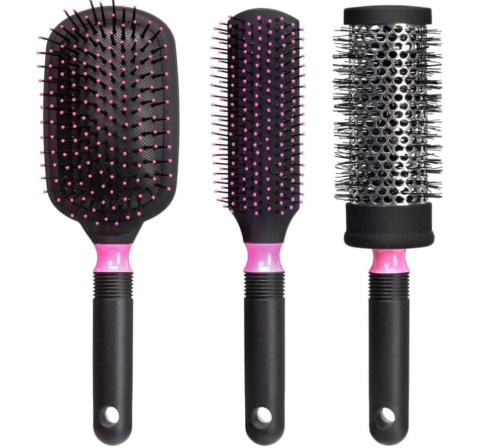 Three varieties of hair brushes on a white surface.
