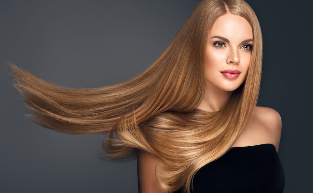 A woman sporting a long straight light brown hair.