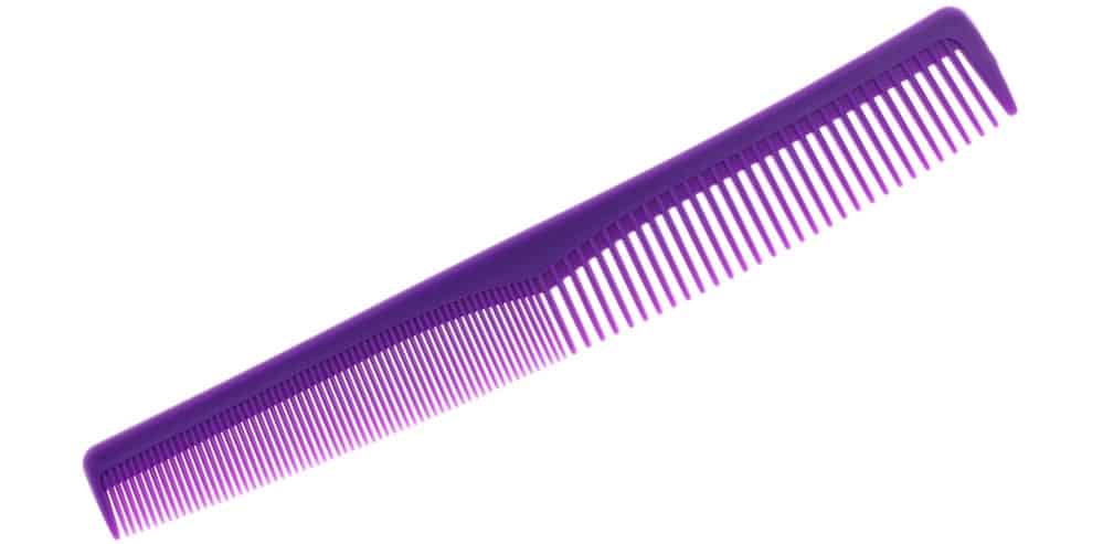 A purple plastic fine-tooth comb.